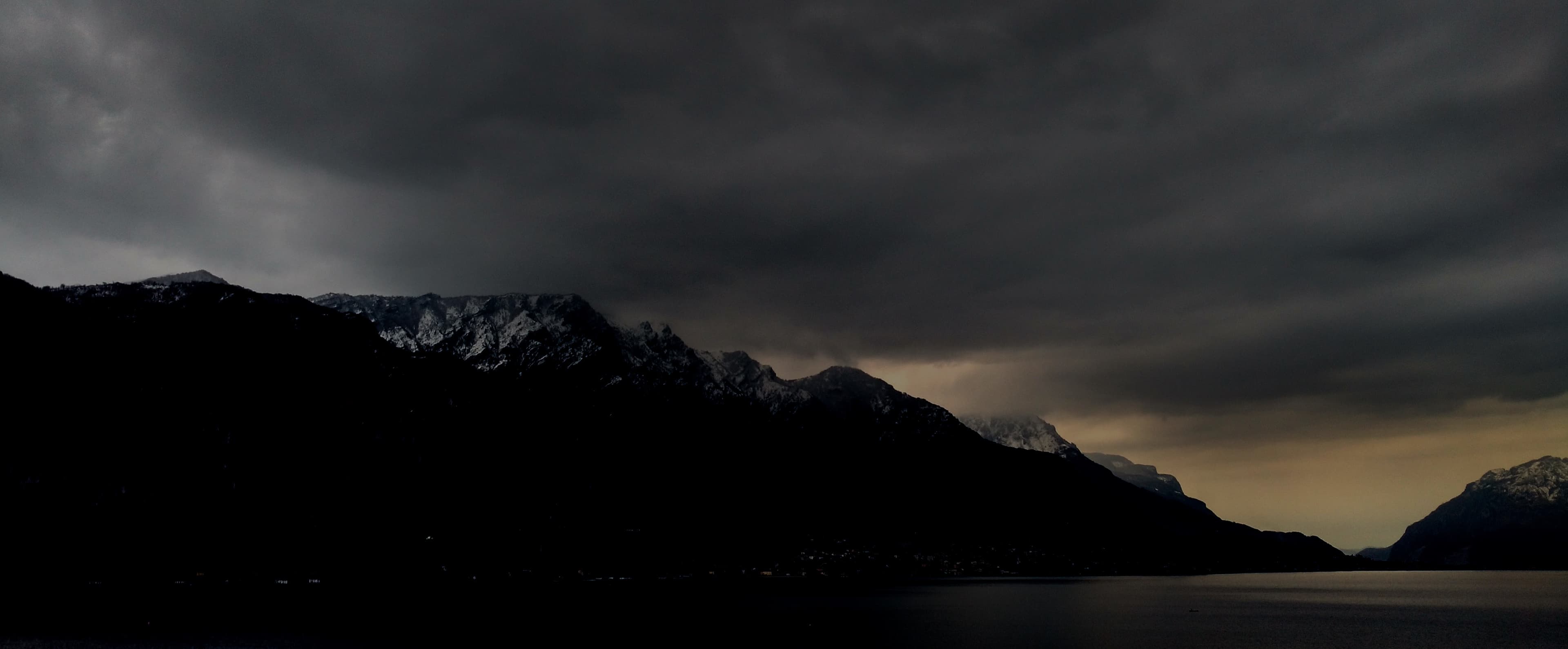 A background image for the top section, a photo of mountains next to a lake, with clouds overhead